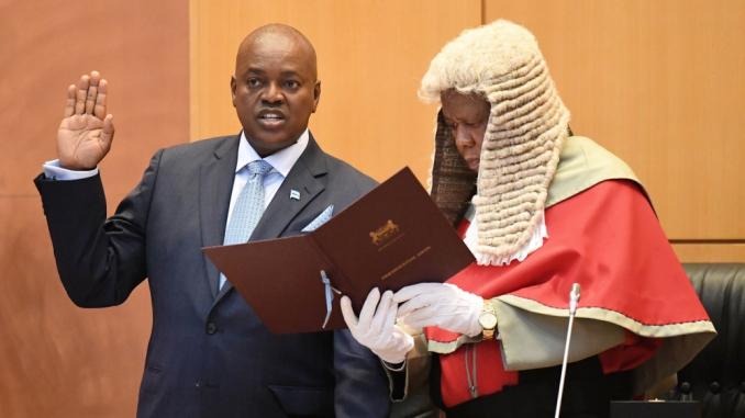 President Masisi, left, takes the oath with the Chief Justice Maruping Dibotelo (photo credit: AFP)