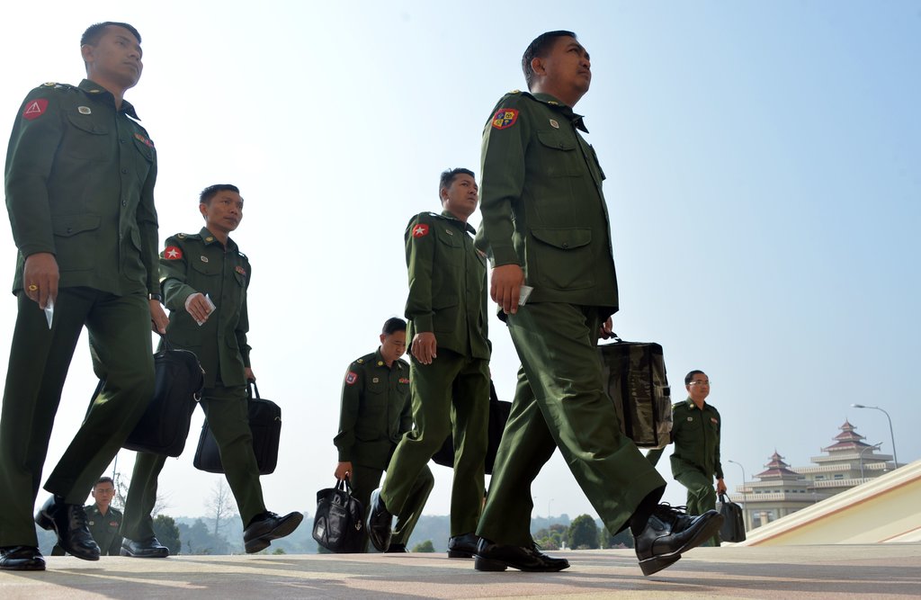 Military officers arriving for a parliamentary session in Naypyidaw, Myanmar, on Tuesday, 19 Feb (photo credit: Thet Aung/Agence France-Presse — Getty Images)