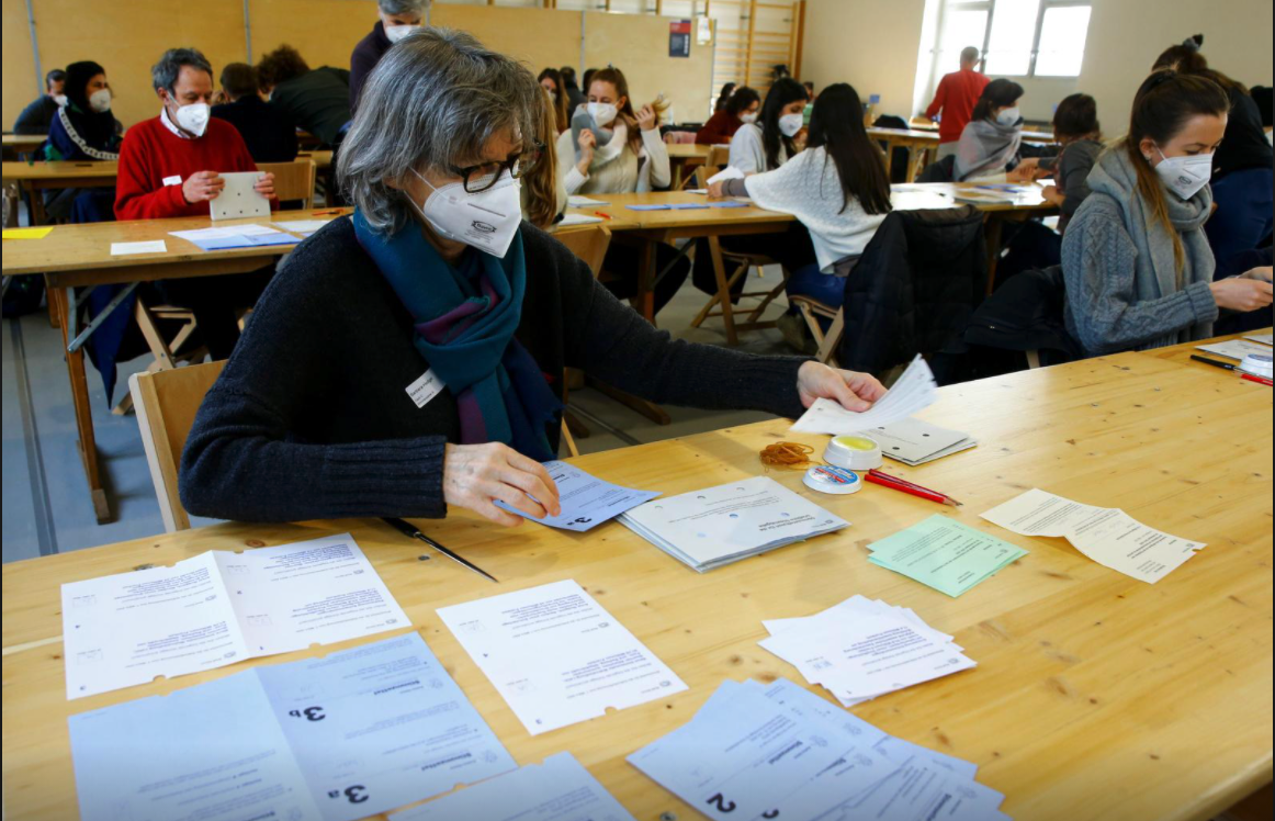 People in a Zurich district election office count ballots on March 7, 2021 (photo credit: REUTERS/Arnd Wiegmann)