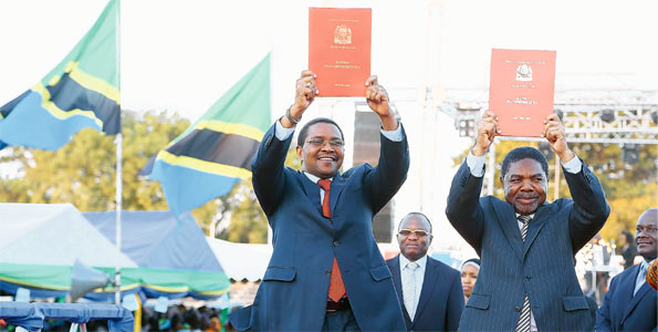 Former President Jakaya Kikwete (left) shows the draft of the constitution