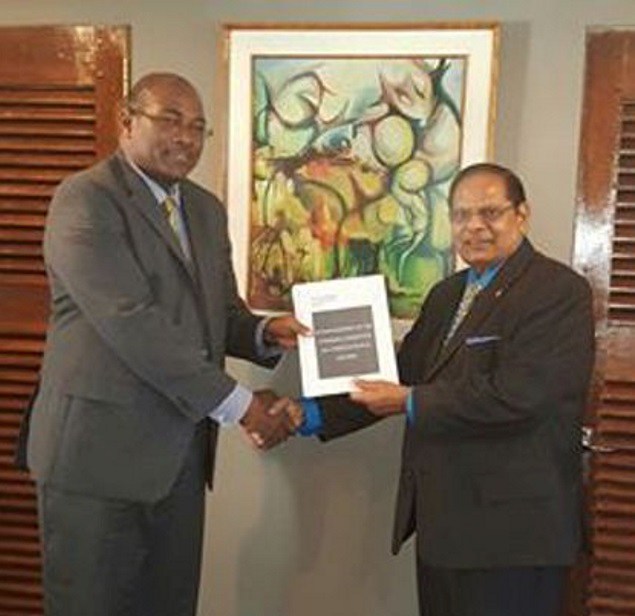 Head of the steering committee on constitutional reform, Nigel Hughes (left) delivering the report to Prime Minister Moses Nagamootoo (photo credit: Demerara waves)