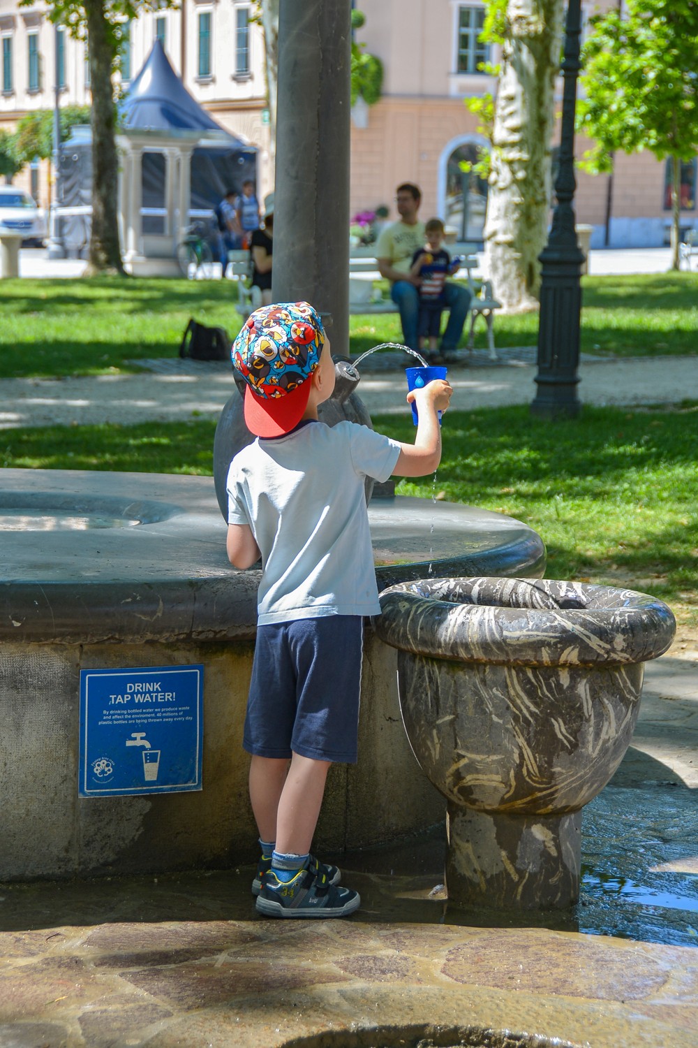 A boy drinks water from a public water tap in Ljubljana (Photo credit: The visit Ljubljana website)
