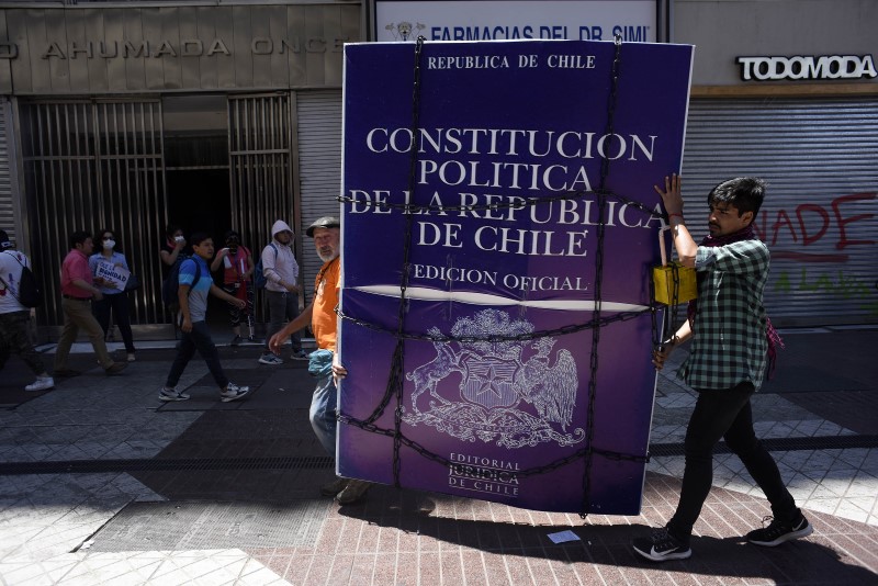 Protestors carry a representation of a padlocked 1980 constitution (photo credit: Claudio Santana via Getty Images)