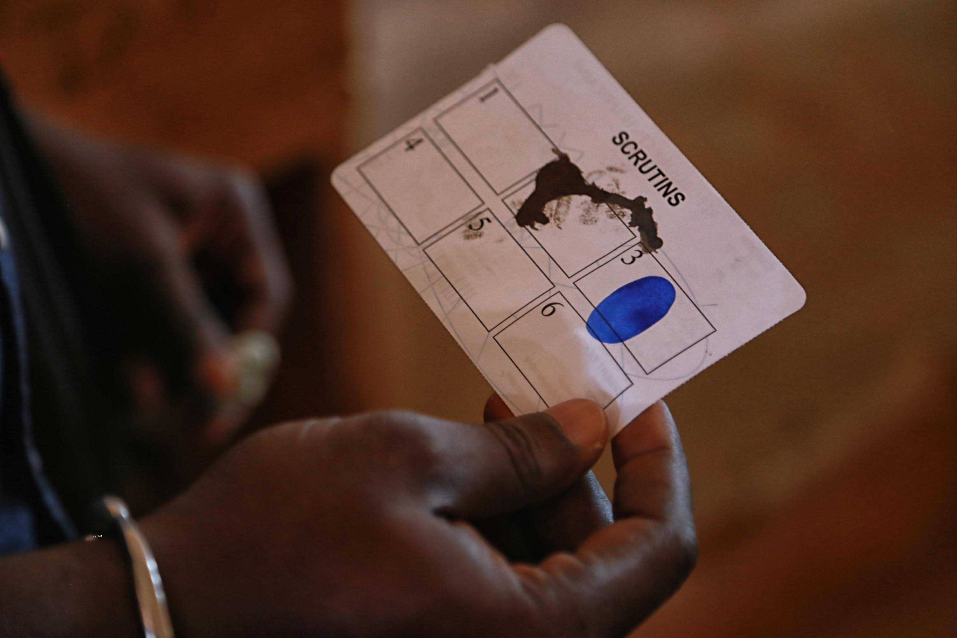 Voter holding a ballot (photo credit: United Nations Photo/flickr)