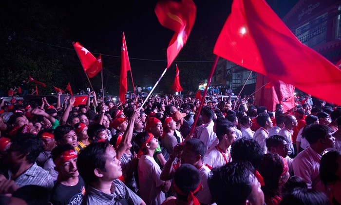 Supporters of Aung San Suu Kyi’s National League for Democracy party cheer as they watch the results of the Myanmar general election on an LED screen in Yangon. (photo credit: Khin Maung Win/AP)