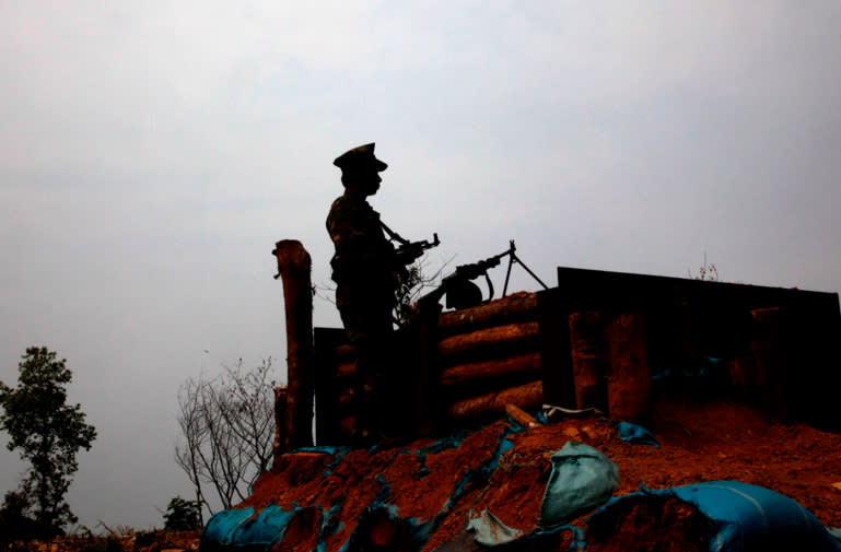 A Kachin Independence Army rebel stands guard at an outpost in the northern state of Kachin (photo credit: AP)