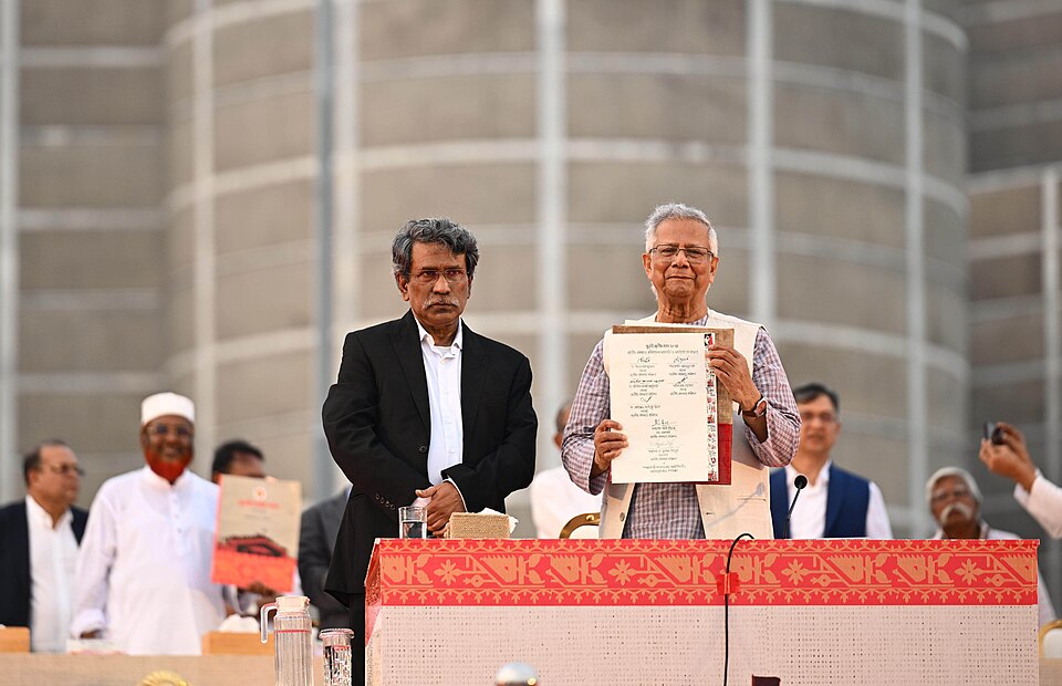 Professor Muhammad Yunus, Chief Advisor and Chairman of the National Consensus Commission, presents the July National Charter to the public after its signing (credit: Press Information Department of Bangladesh via Wikimedia Commons)