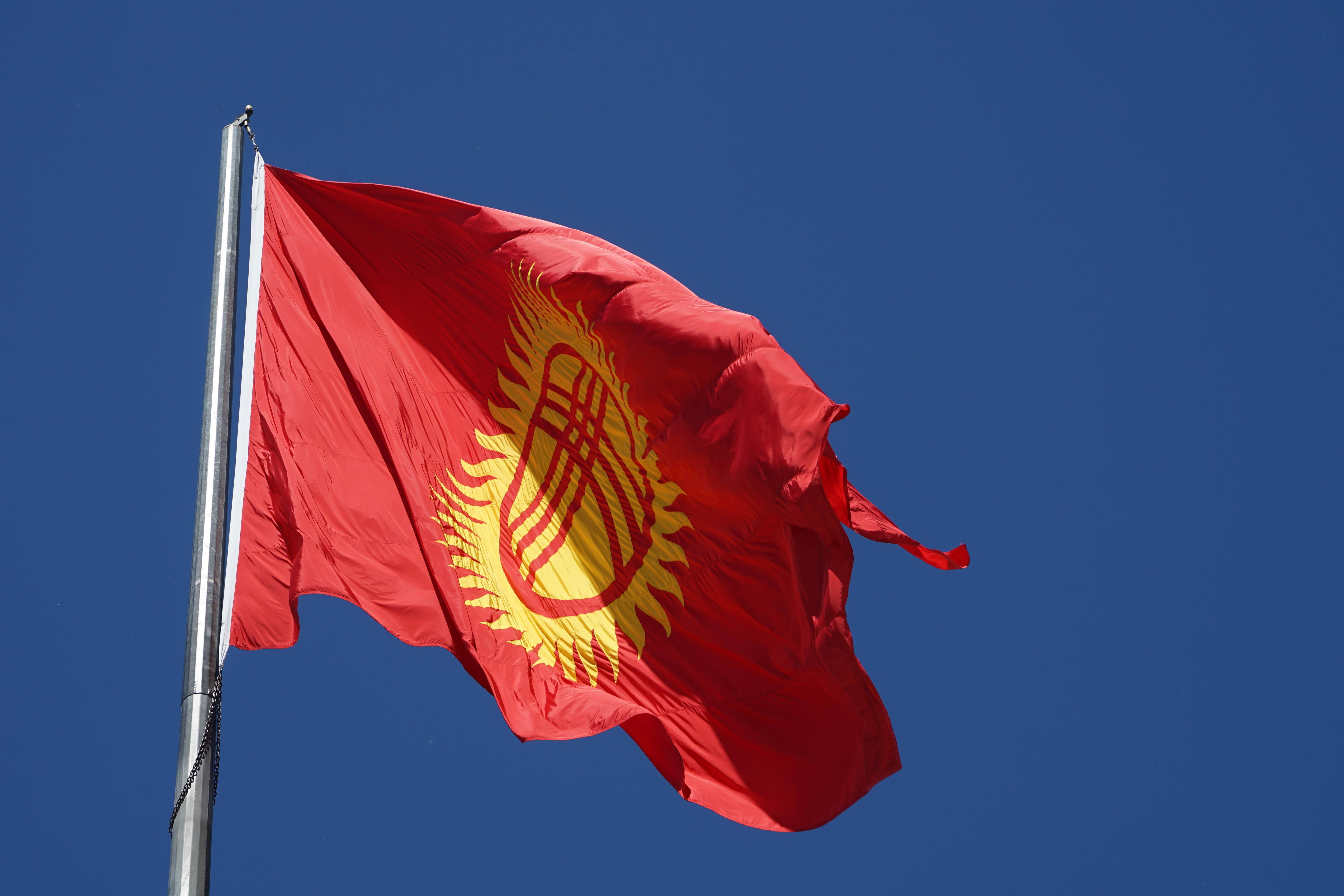 Flag of Kyrgyzstan (photo credit: Kalpak Travel/flickr)
