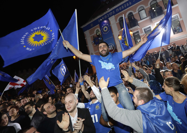Supporters of the ruling Georgian Dream party celebrate after its win in Oct 2016 (photo credit: AP Photo/Sergei Grits)