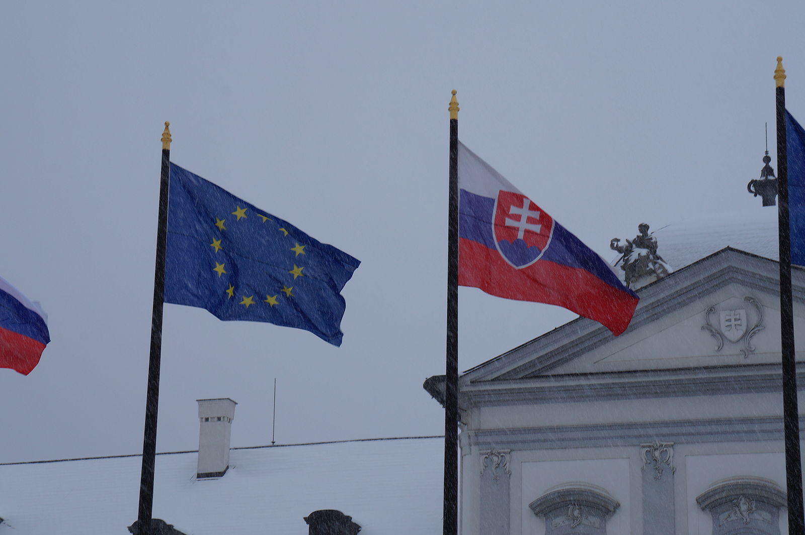 Slovak flag and European Union flag under the rain (credit: Kiwiev via Wikimedia Commons)