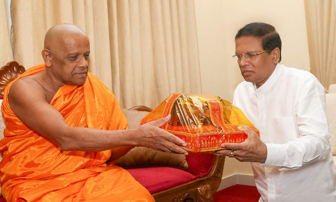 President Maithripala Sirisena with a Buddhist priest (photo credit: Colombo Page)