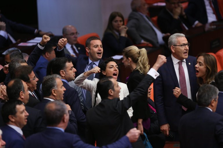 Members of the National Assembly shout slogans during a vote on the measure, which would clear the way for the prosecution of many Kurdish lawmakers for alleged ties to militants (Photo credit European Pressphoto Agency)