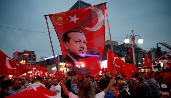 Supporters hold a flag depicting Turkish President Recep Tayyip Erdogan (photo credit: REUTERS/Baz Ratner) 