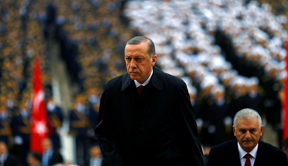 Turkish President Recep Tayyip Erdogan flanked by Prime Minister Binali Yildirim (R)  (photo credit: Reuters/Umit Bektas) 
