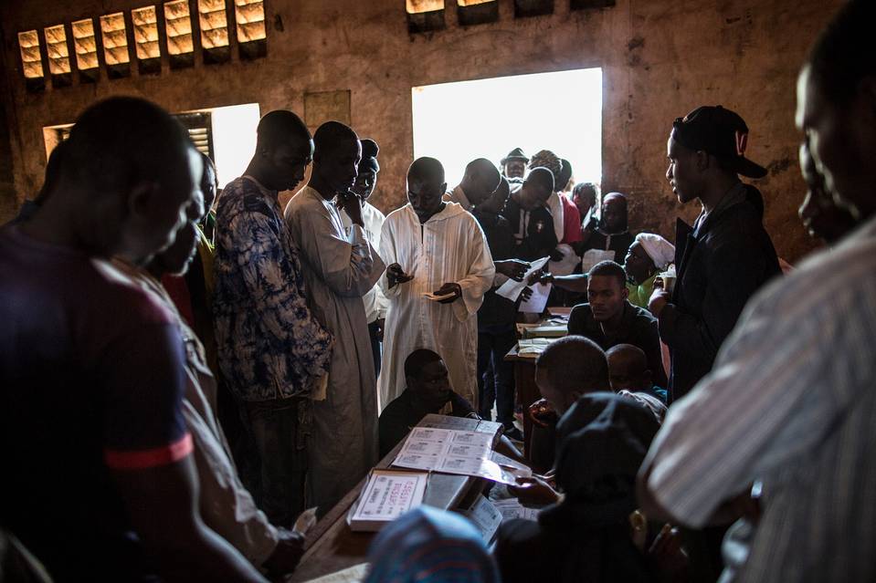 Voters collect their cards at the polling station at the Koudoukou school in the PK5 district in Bangui on Monday. (photo credit: AFP)