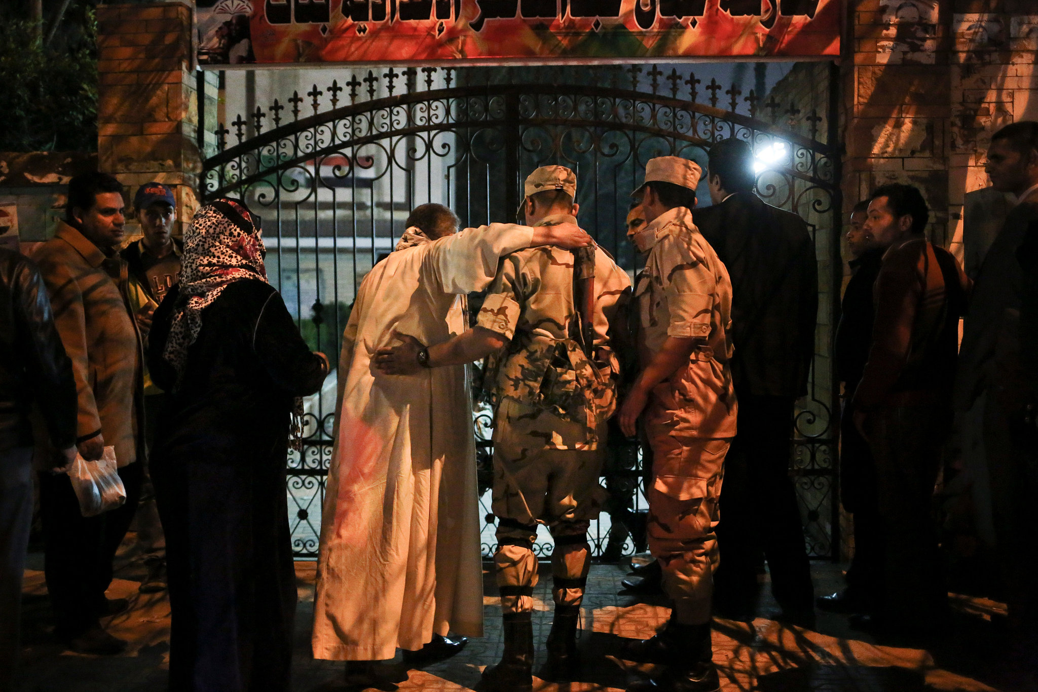 On Tuesday, soldiers helped a man into a polling station in Cairo, where Egyptia