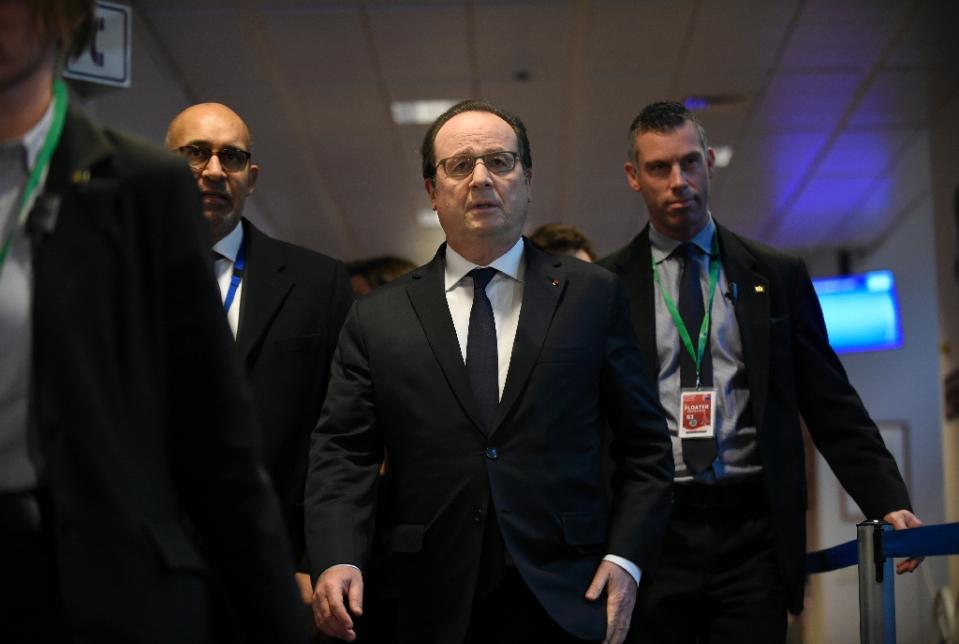 French President Francois Hollande (C) is under fire for seeking changes to the constitution that could strip dual-nationals of their French passport (photo credit: AFP)