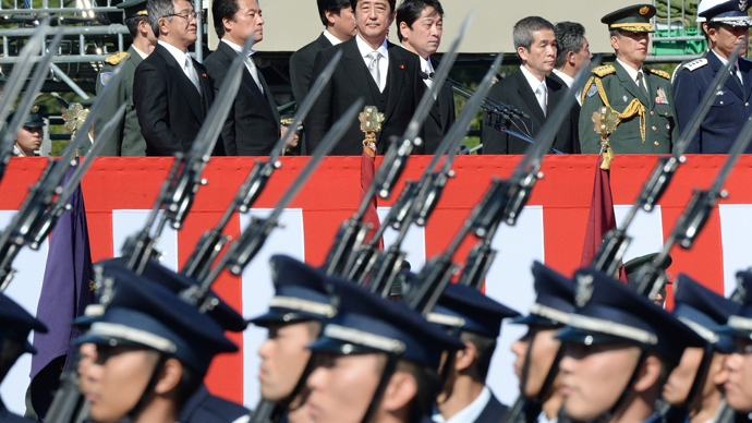 Japanese Prime Minister Shinzo Abe (top C) inspects troops of Japan's Self-Defence Force (Photo credit: AFP/Toru Yamanaka)