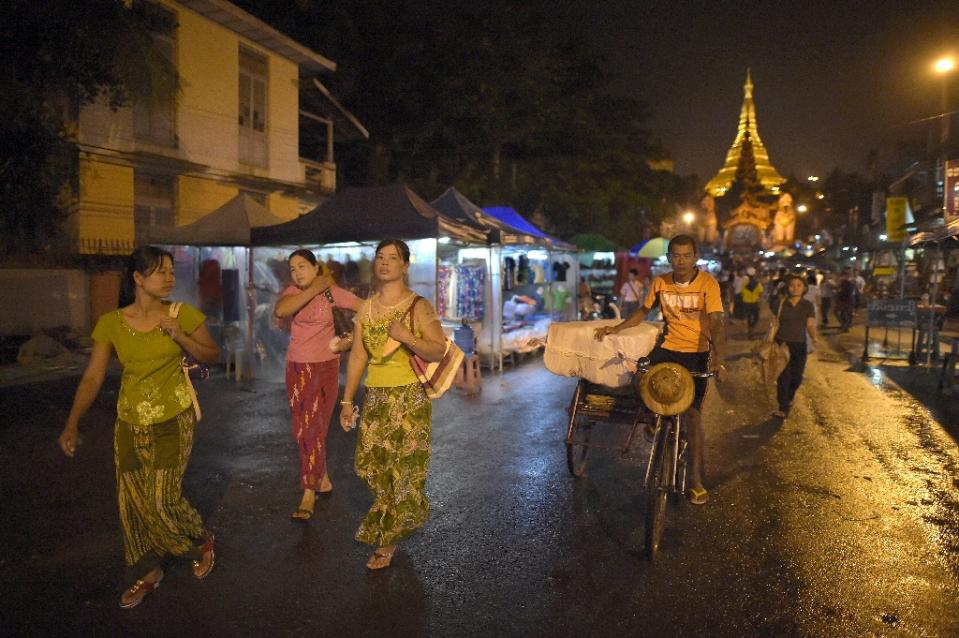 People walk in a street of Yangon on November 12, 2015 (photo credit: AFP)