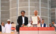 Professor Muhammad Yunus, Chief Advisor and Chairman of the National Consensus Commission, presents the July National Charter to the public after its signing (credit: Press Information Department of Bangladesh via Wikimedia Commons)