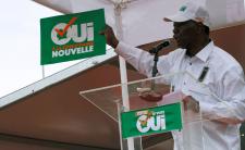 President Alassane Ouattara holds a "Yes to a new Ivory Coast" placard 	(photo credit: Reuters/Luc Gnago)