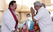 President Gotbaya Rajapaksa - right - swears in his brother and former President Mahinda Rajapaksa as Prime Minister (photo credit: Reuters)