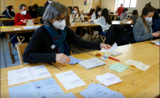 People in a Zurich district election office count ballots on March 7, 2021 (photo credit: REUTERS/Arnd Wiegmann)