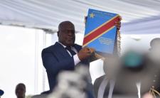 Tshisekedi holds constitution during his inauguration (photo credit: Olivia Acland/Reuters)