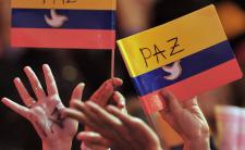 Supporters of the peace (Paz) process hold the Colombian flag (photo credit: Warscapes)
