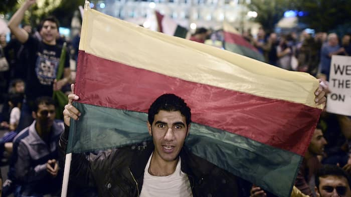 A man holding the flag of the Syrian Kurdish People's Democratic Union Party (PYD) (photo credit: AFP)