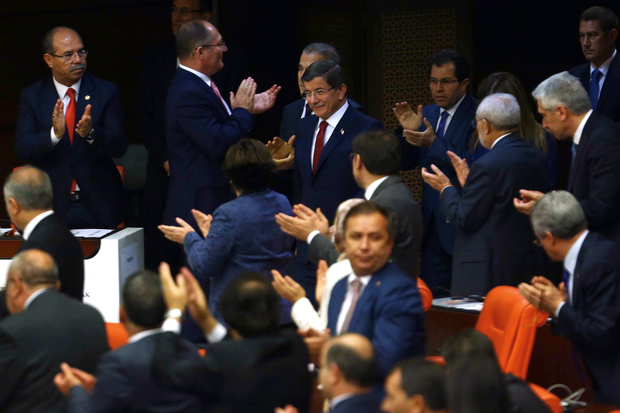 Turkish MPs applaud outgoing Prime Minister Ahmet Davutoglu during constitutional debates on Tuesday (photo credit: AFP)