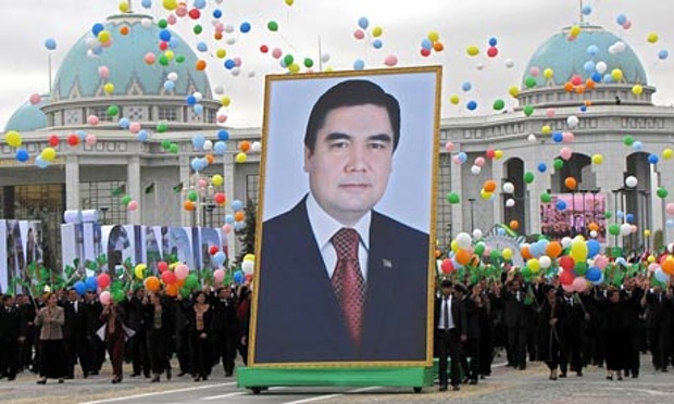 People carry a picture of the Turkmen President Kurbanguly Berdymukhamedov (photo credit: Str/AFP/Getty Images)